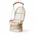 Hanging macrame chair in natural color with wooden frame and cushions